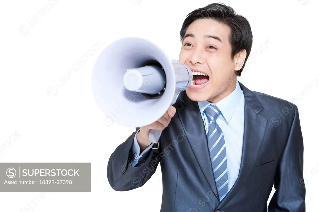 Portrait of a businessman shouting into a megaphone