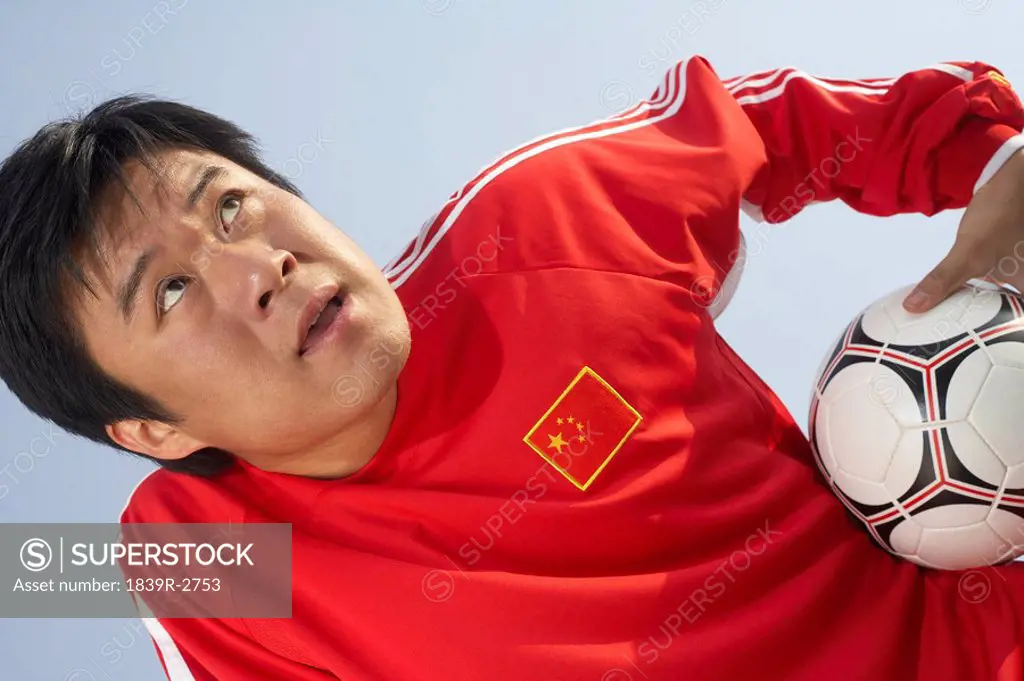 Chinese Soccer Player Holding Soccer Ball
