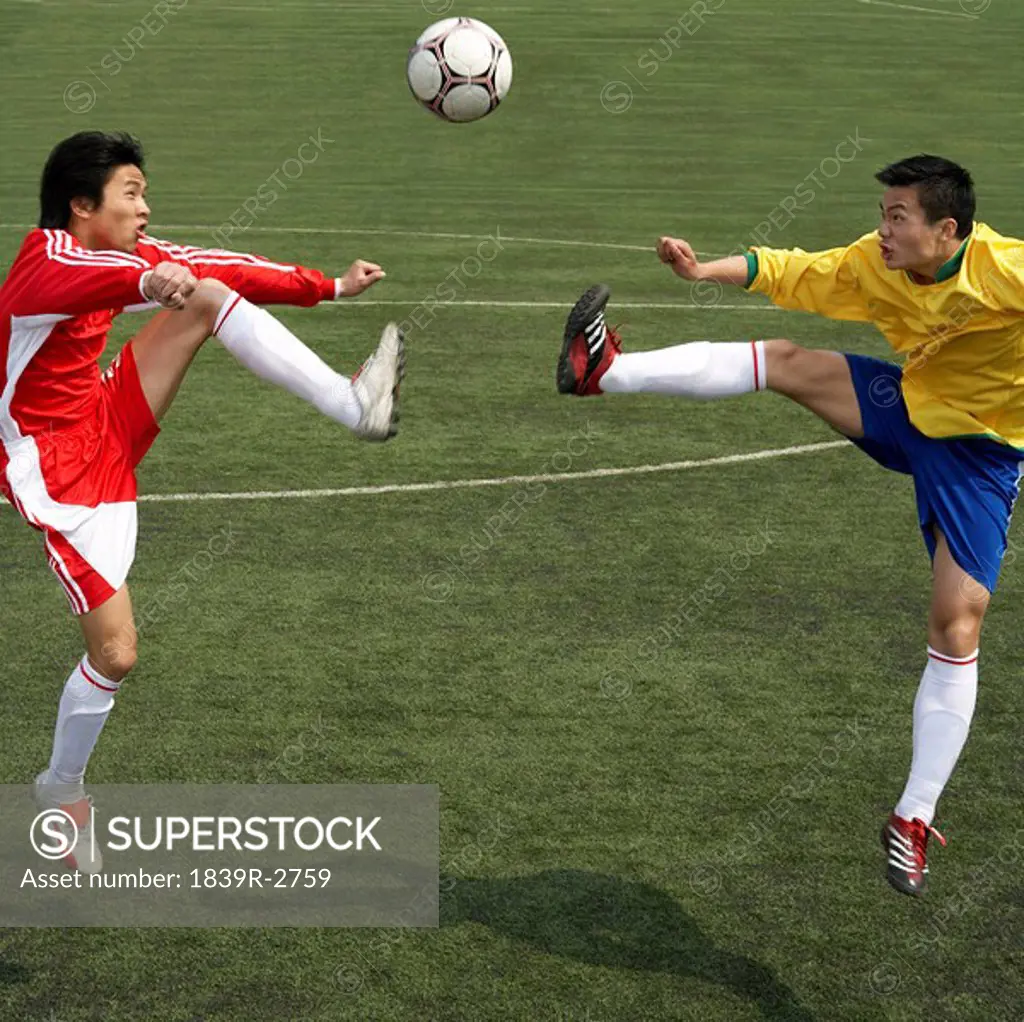 Two Soccer Players Jumping For The Ball