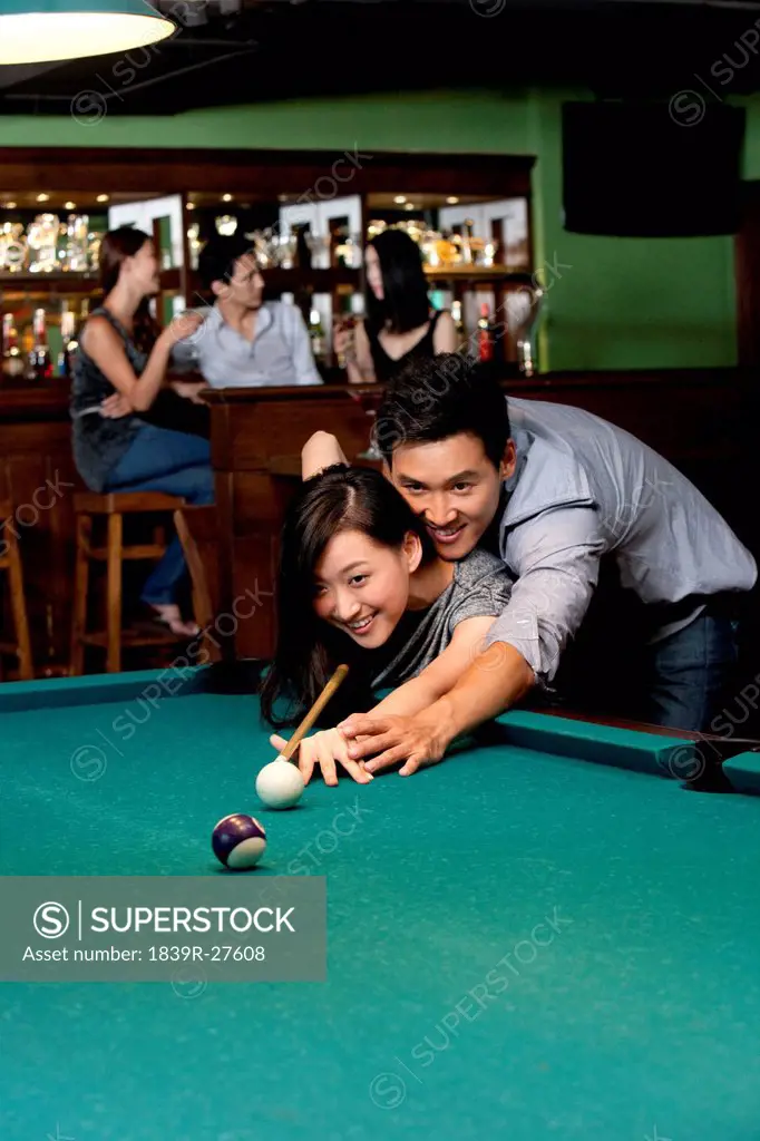 Couple Playing Pool Together