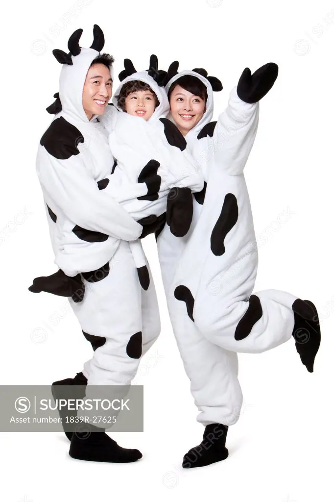 Family in cow costumes embracing each other