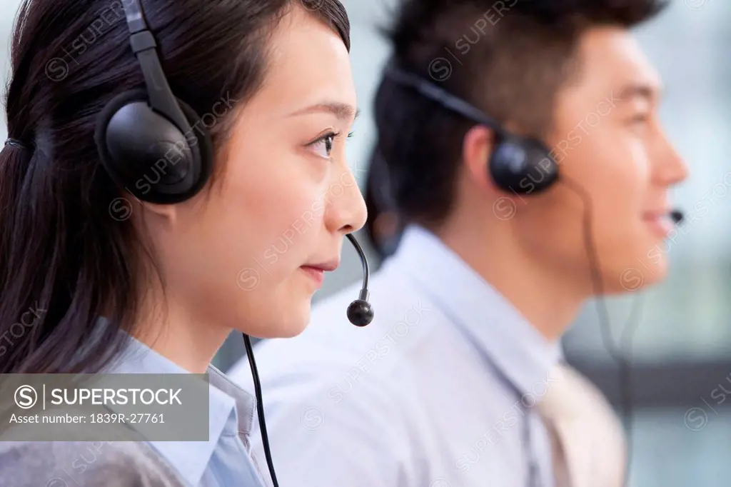 Side view of call center agents with headsets