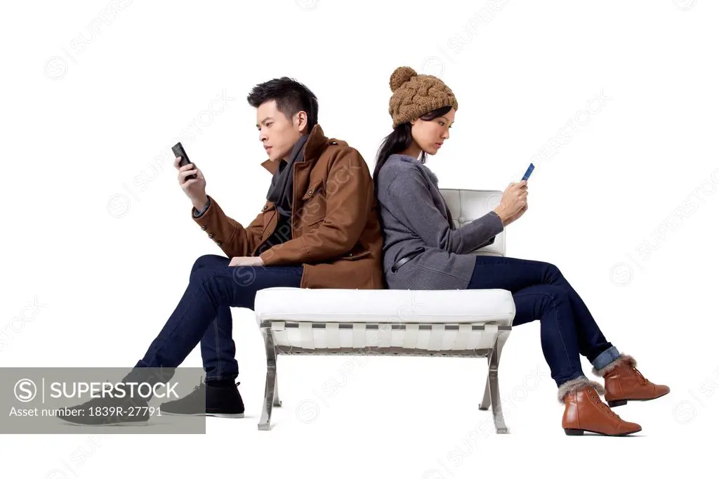 Stylish young people using mobile phone