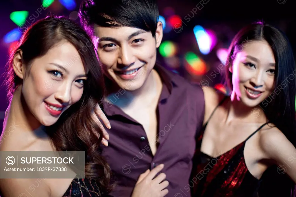 Young man surrounding by beautiful women in nightclub