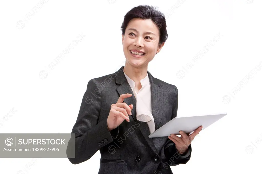Middle_aged businesswoman using digital tablet