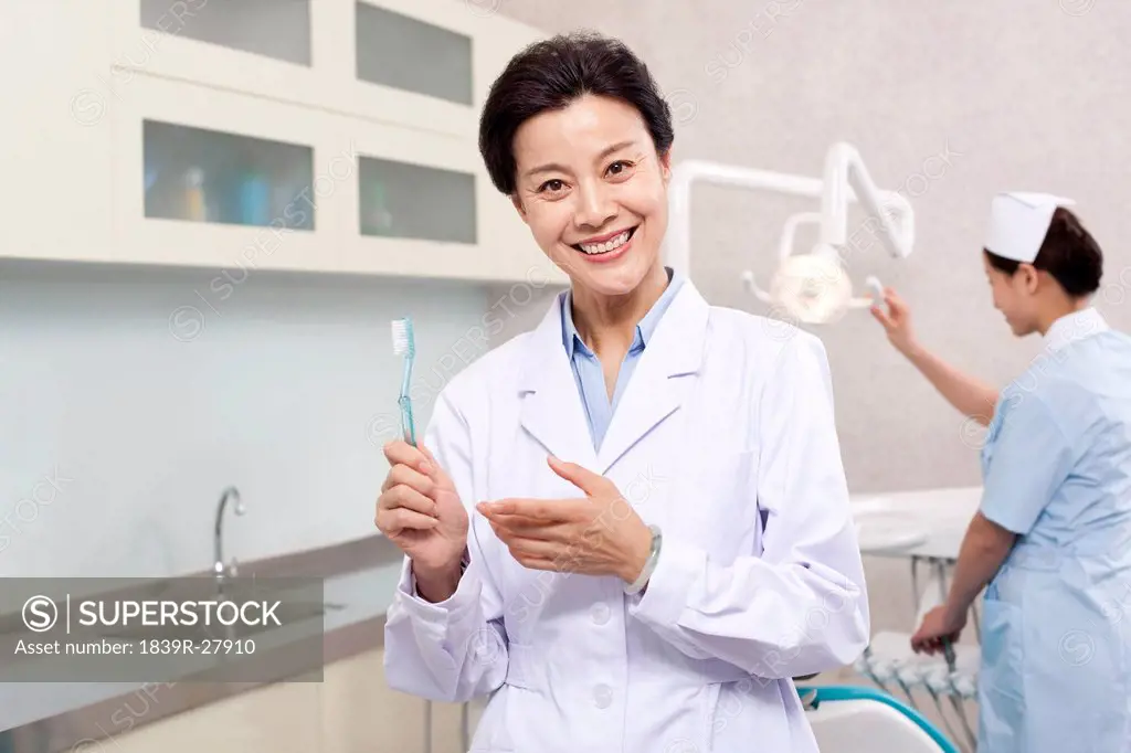Dentist holding a toothbrush in dental clinic