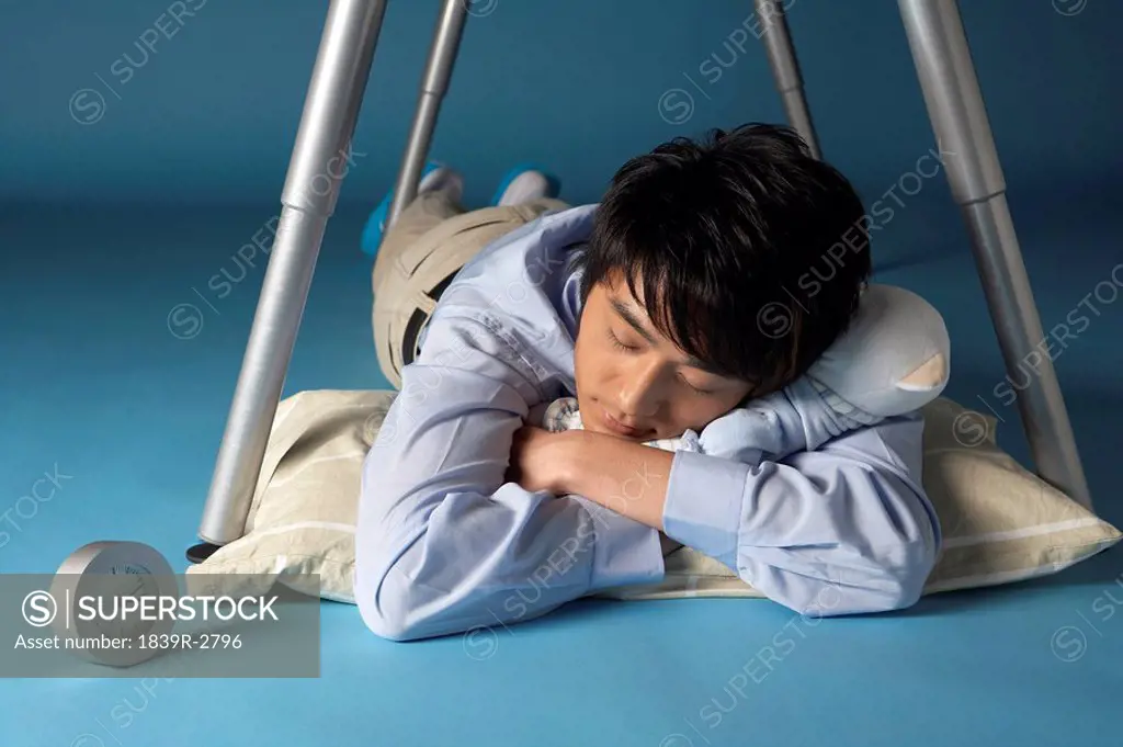 Man Sleeping Under His Desk
