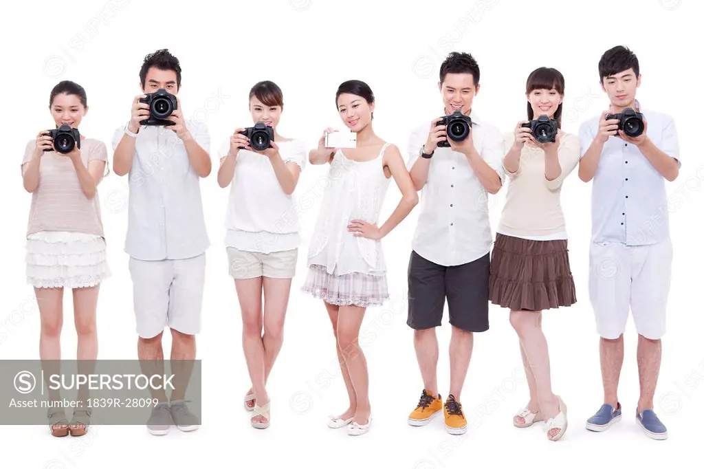 Young people photographing with different cameras
