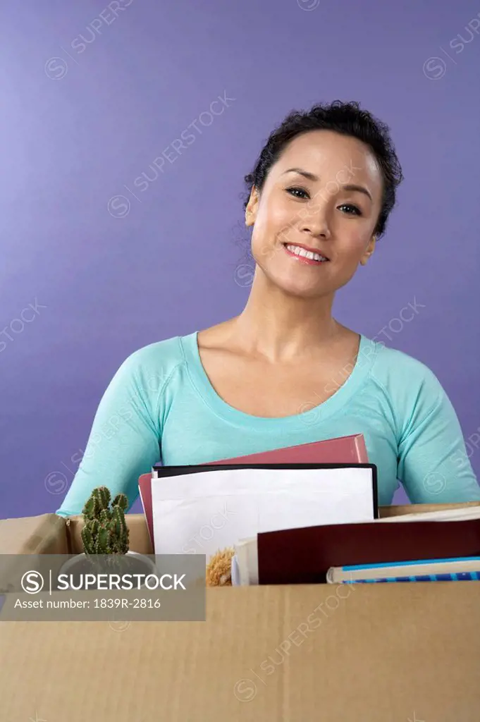 Young Woman Clearing Out Desk