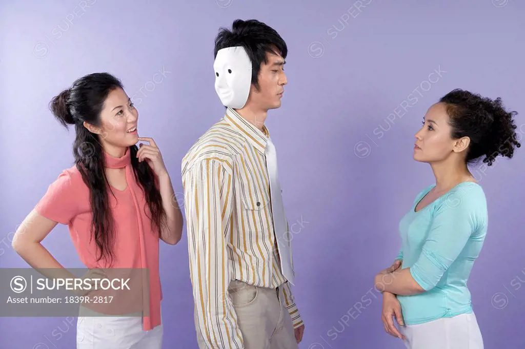 Young Women Talking To A Two_Faced Man