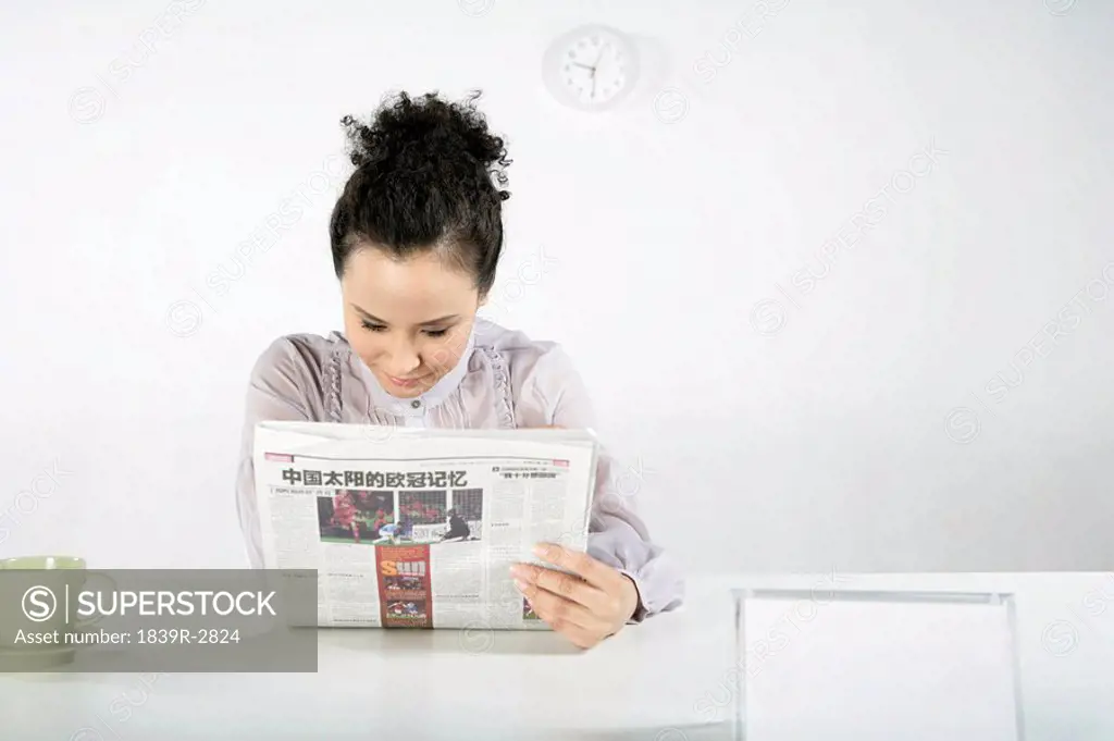 Businesswoman Reading Newspaper