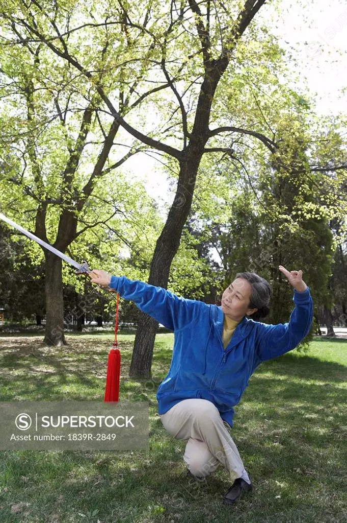 Woman Practicing Martial Arts With A Sword