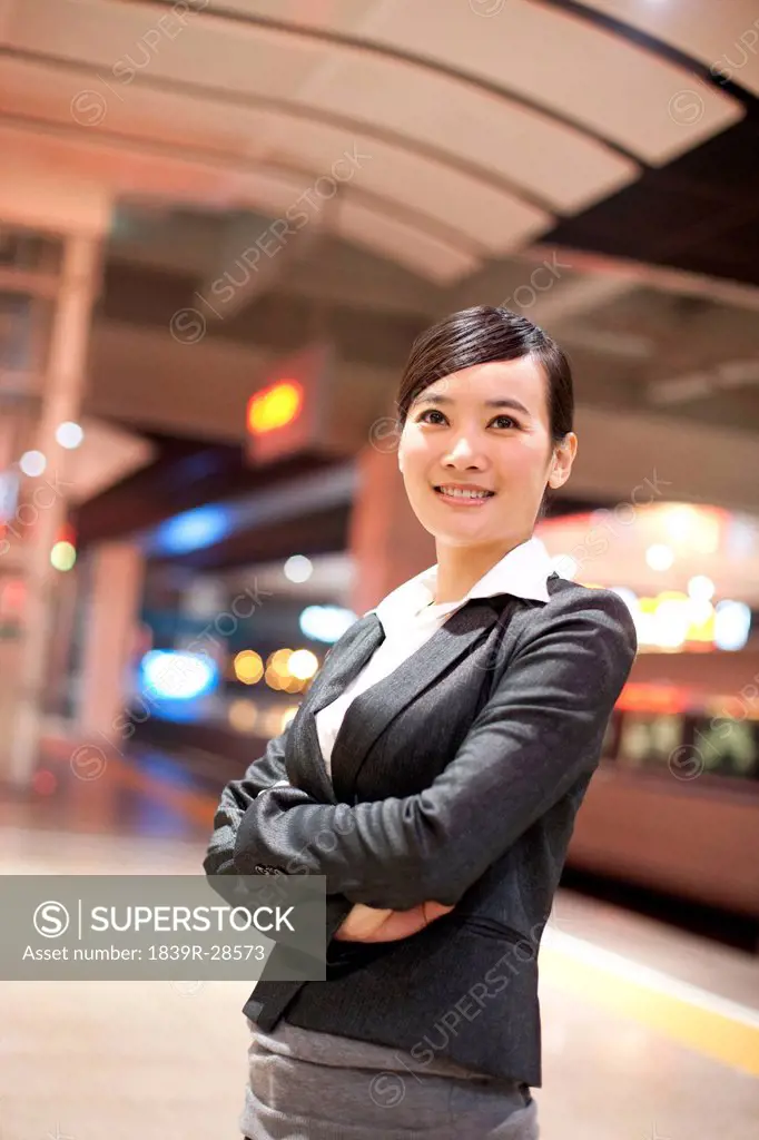 Young businesswoman contemplating at the train station