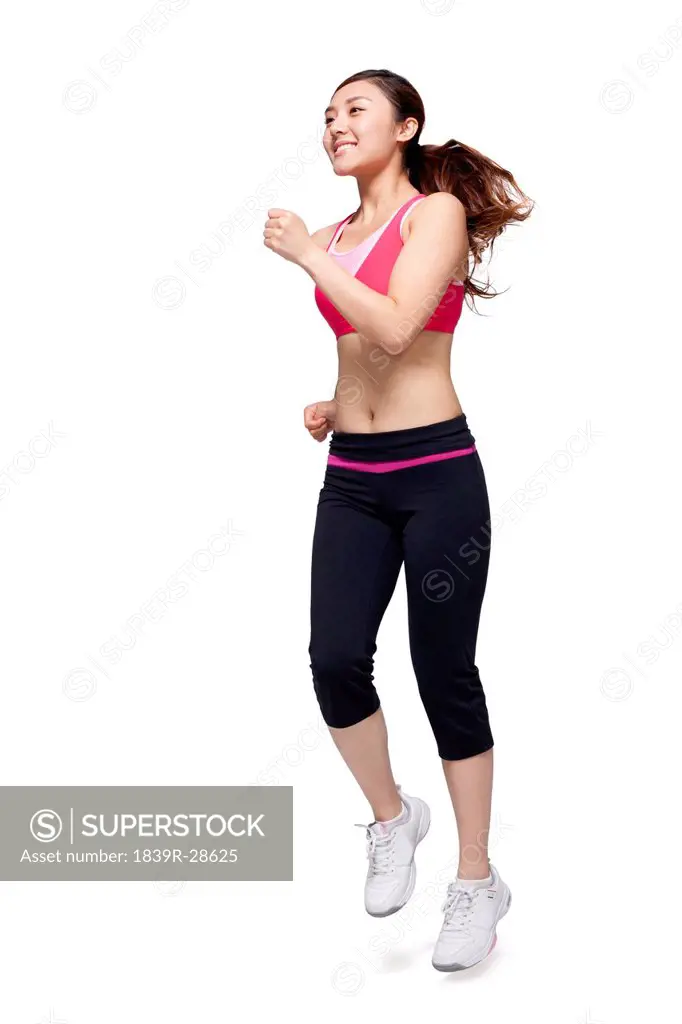 Young woman in sports clothing jumping