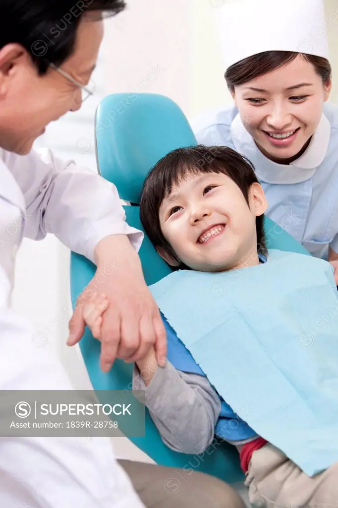Little patient receiving treatment in dental clinic