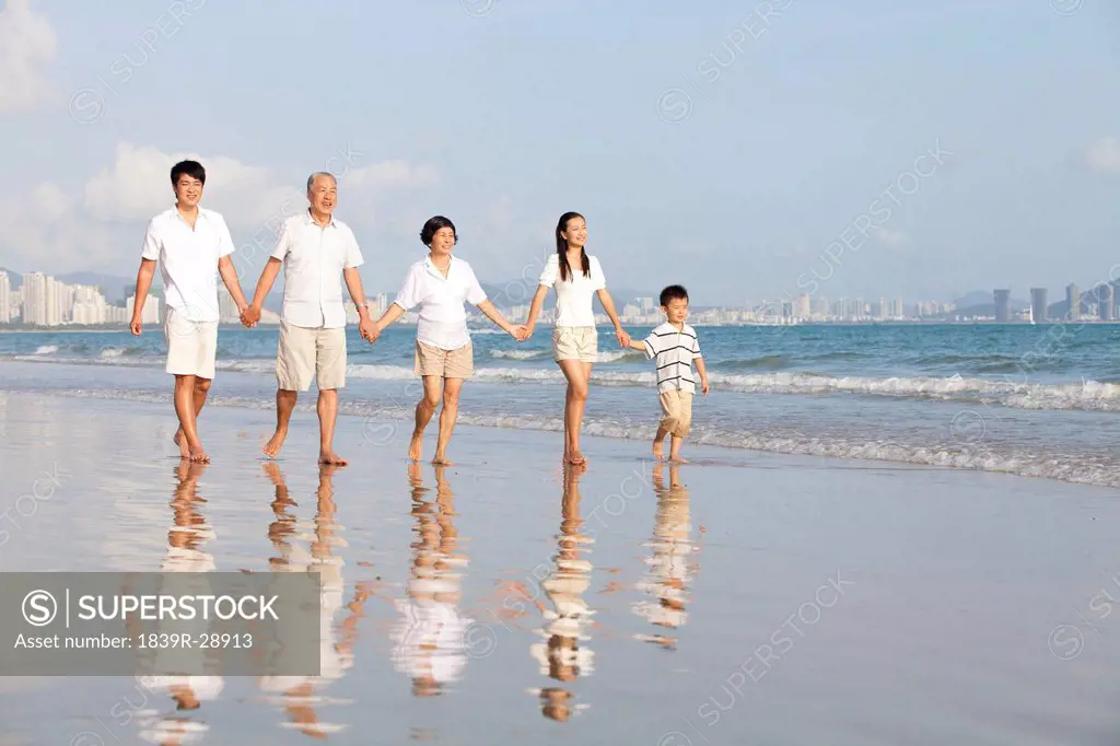 Portrait of a family walking on the beach