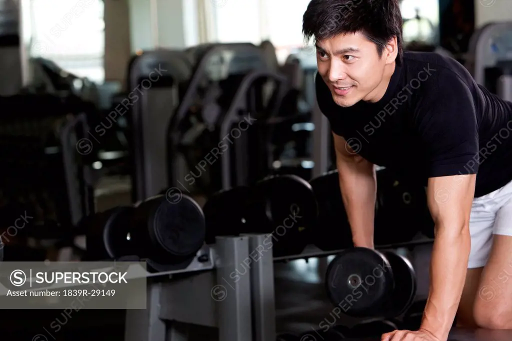 Mid_Adult Man Lifting Weights