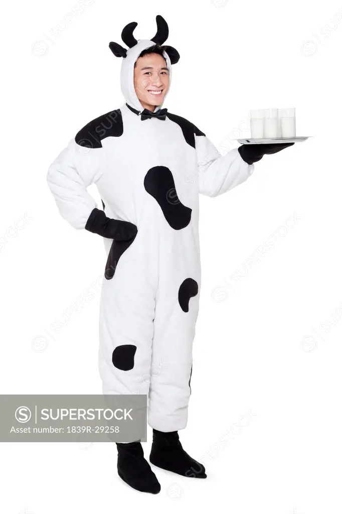 Man in cow costume with a serving tray of milk