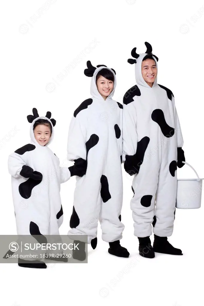 Family in cow costumes in a row