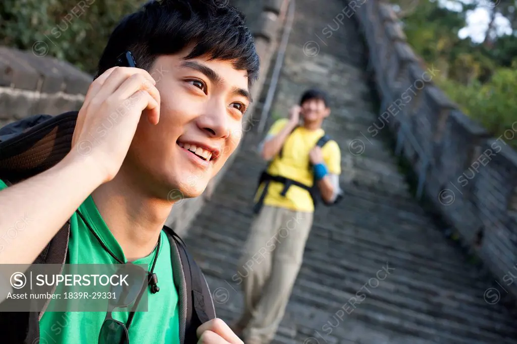 Young people talking on the walkie_talkie on the Great Wall