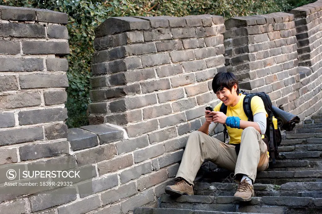 Young people using cellphone on the Great Wall