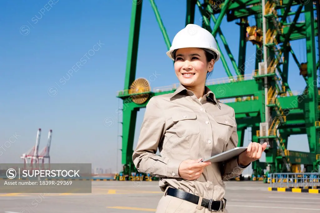 Female shipping industry worker with clipboard