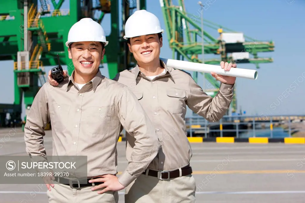 Male shipping industry workers smiling
