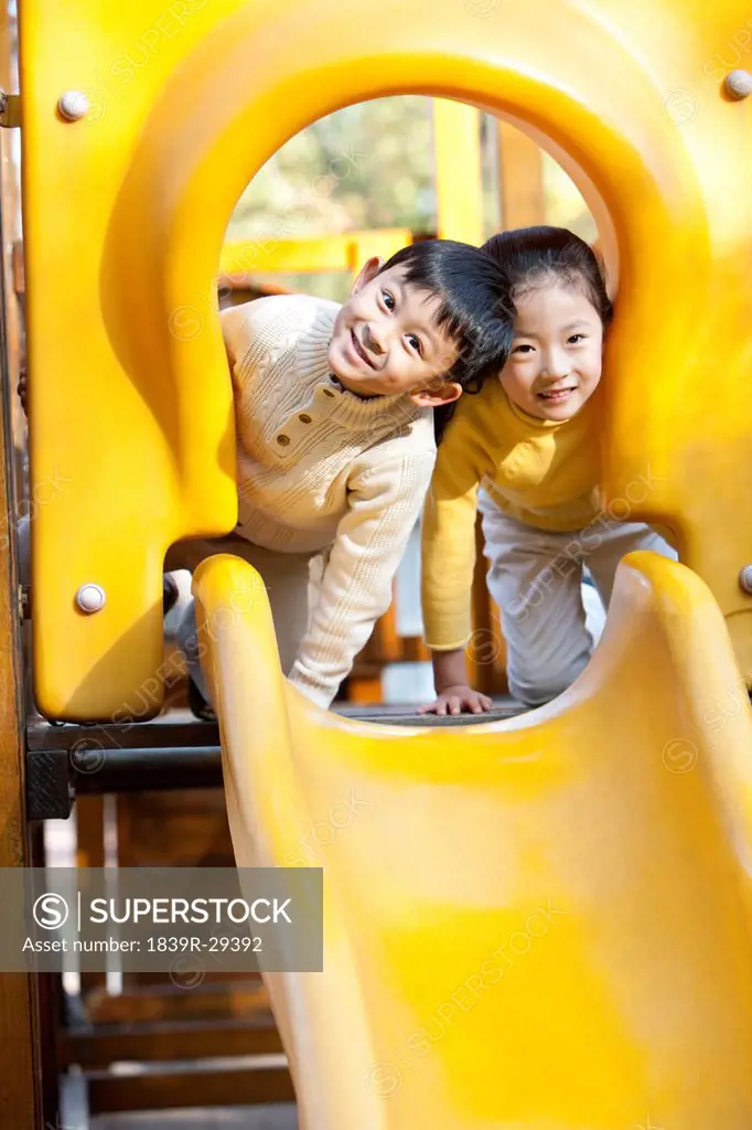 Children playing on playground slide