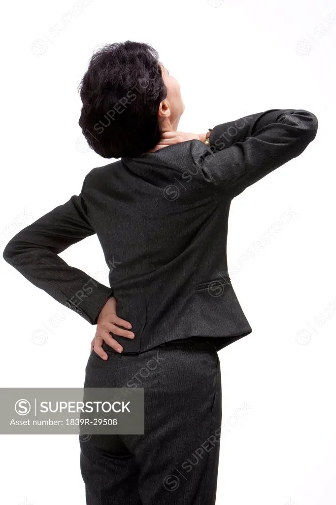 Middle_aged businesswoman suffering from backache and neck ache