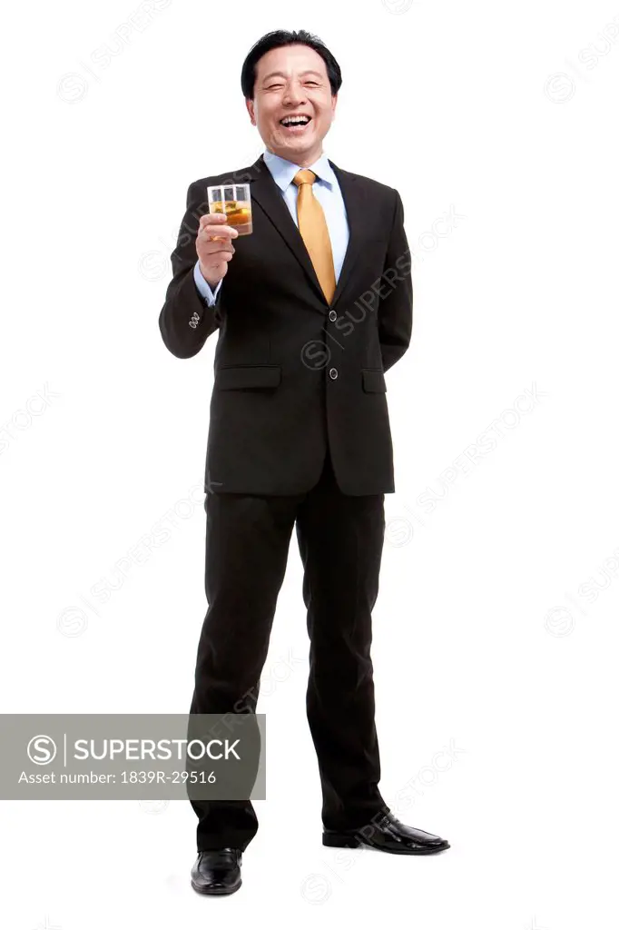 Senior businessman holding a glass of whiskey