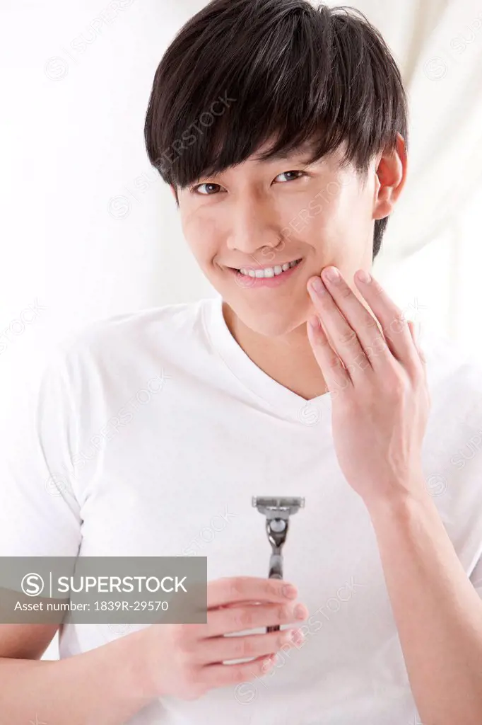 Young man doing shaving