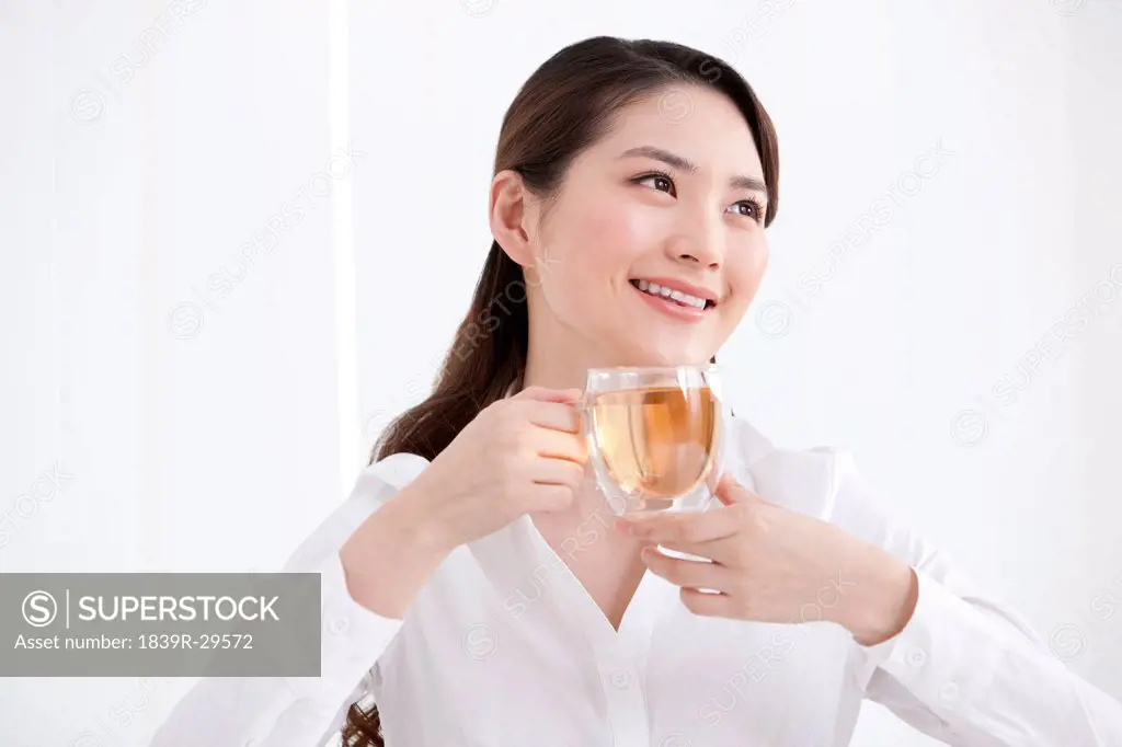 Young businesswoman having tea
