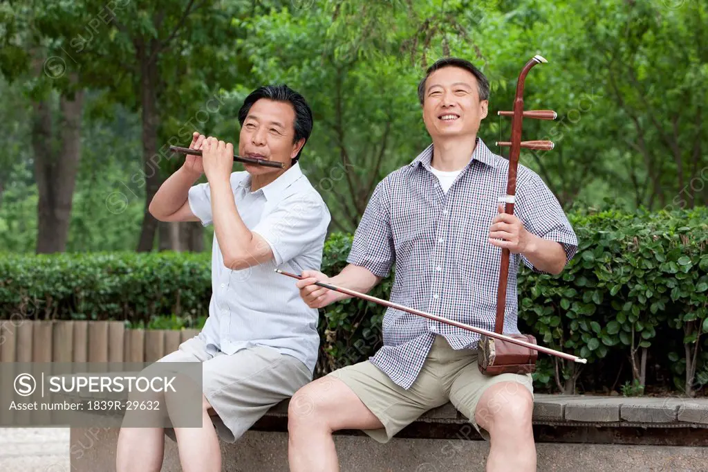 Old men playing Chinese traditional instrument in park