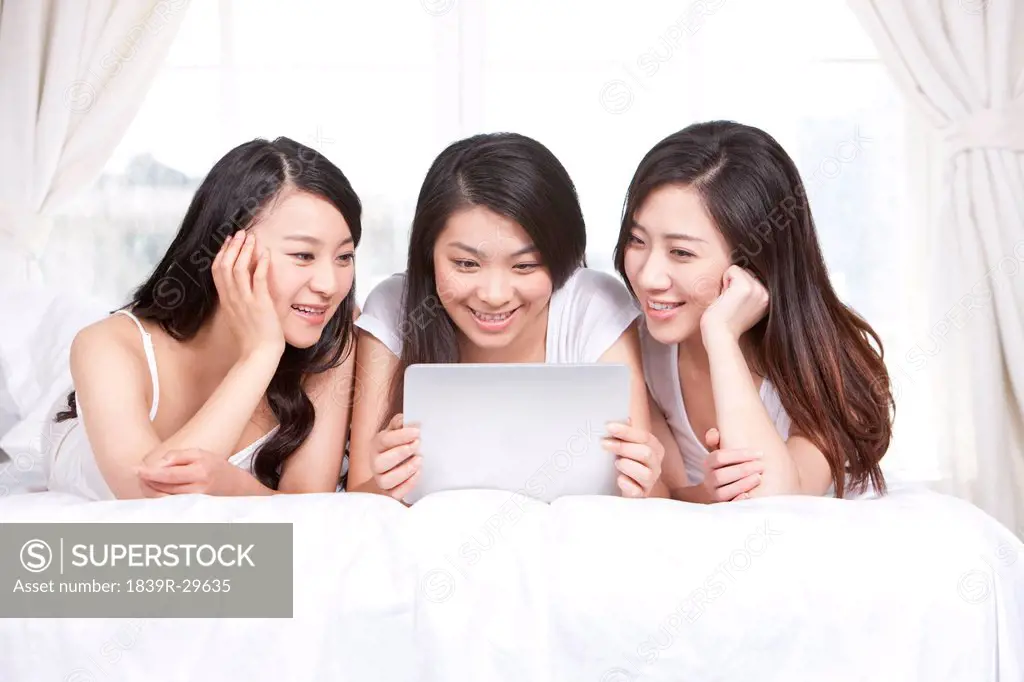 Best female friends using digital tablet at home