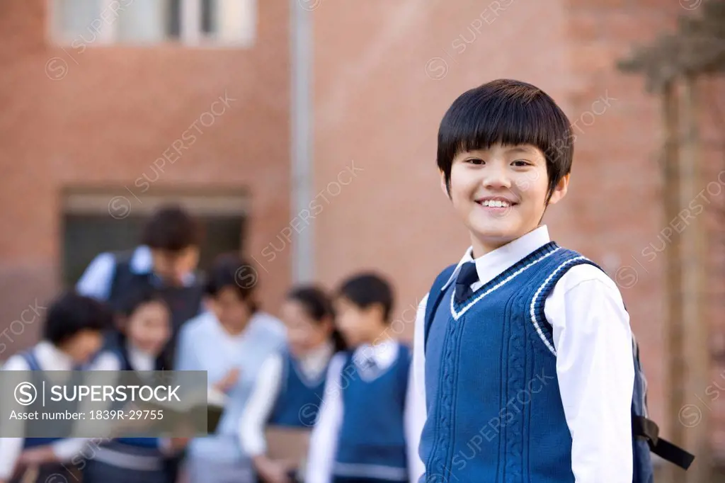 Young student standing confidently in the foreground