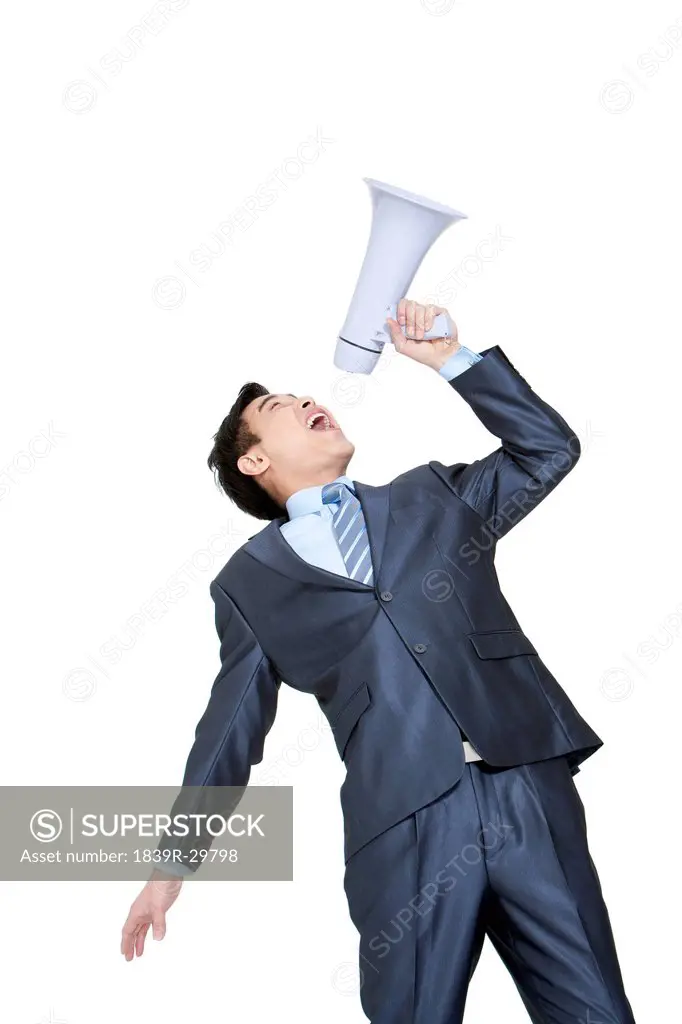Portrait of a businessman shouting into a megaphone