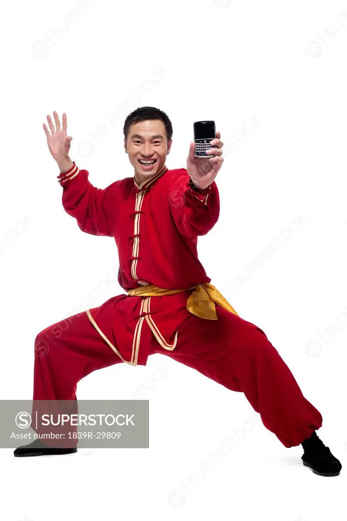 Excited Man In Traditional Chinese Clothing Holding Up a Mobile Phone
