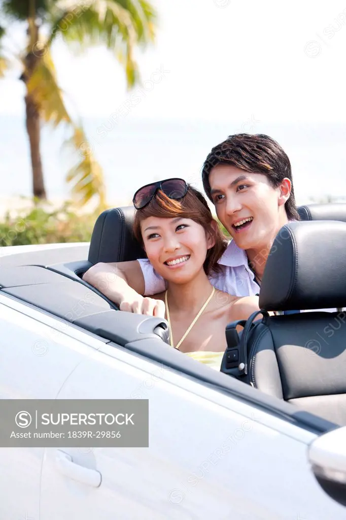 Couple Sitting in the Back Seat of a Convertible