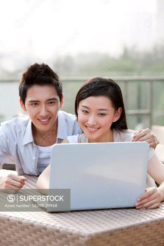 Couple Using Laptop, Outdoors