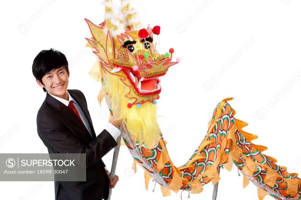 Businessman practising Chinese dragon dancing