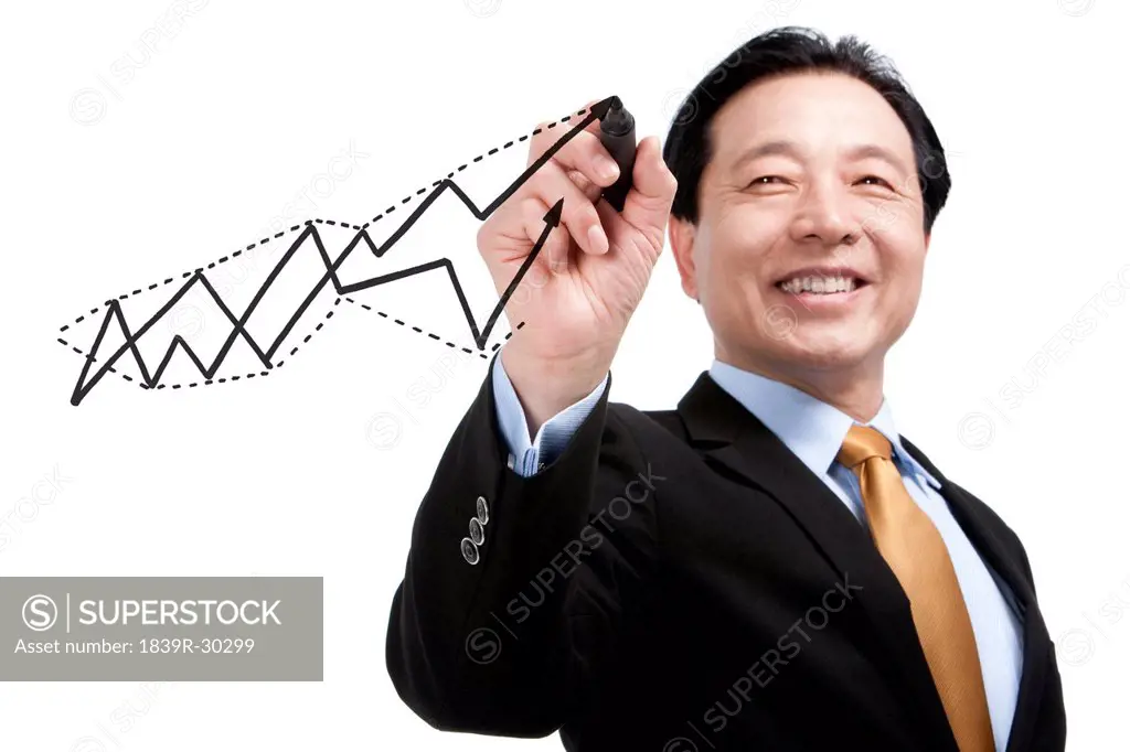 Senior businessman drawing a diagram