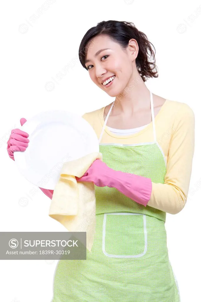 Happy housewife drying the plate