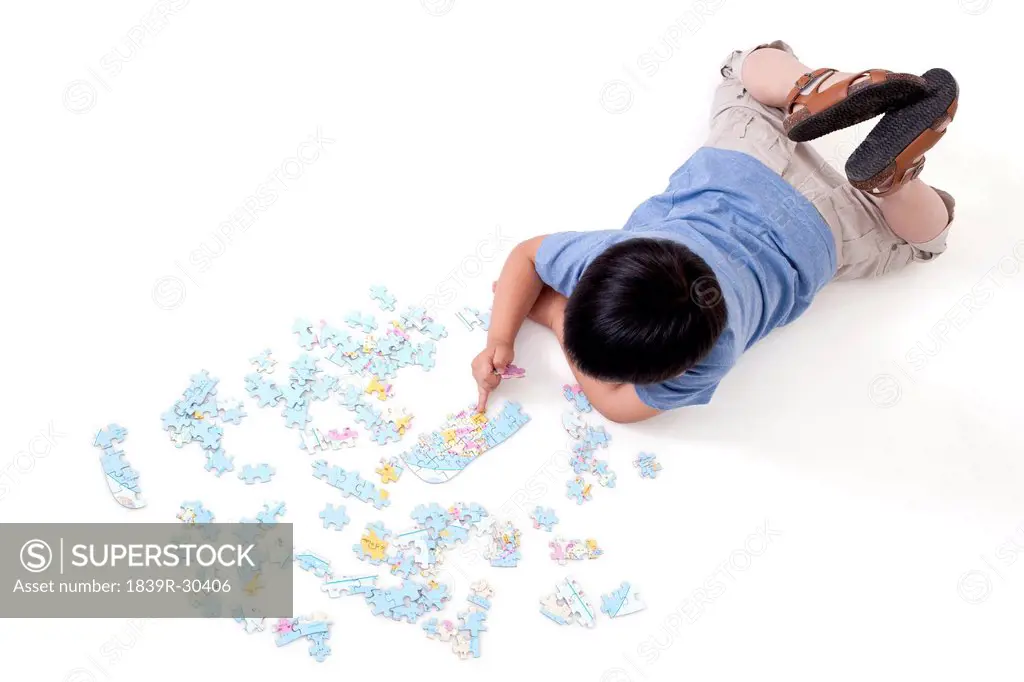 Boy playing jigsaw puzzles