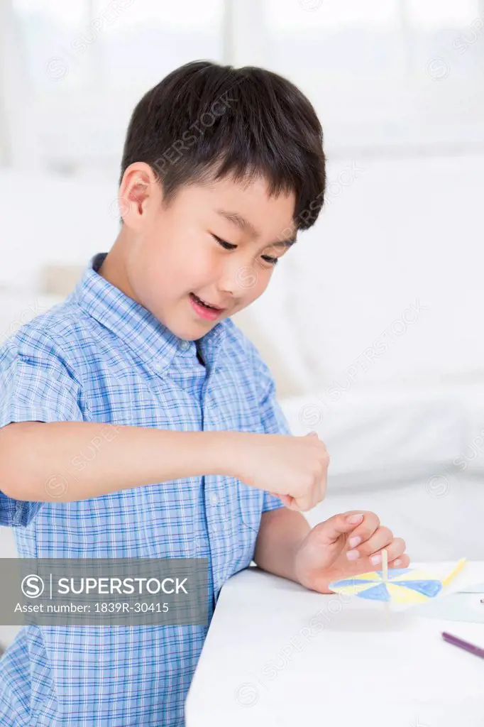 Boy playing a paper toy