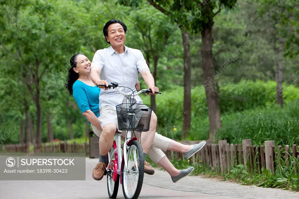 Senior couple cycling in park