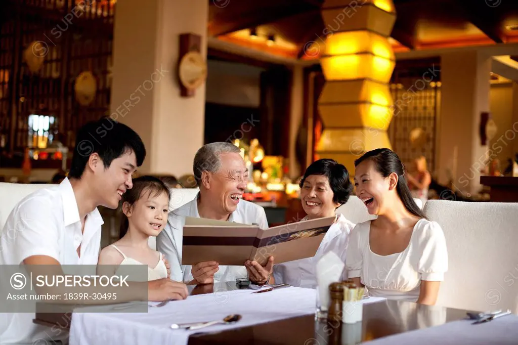 Happy family looking through a menu