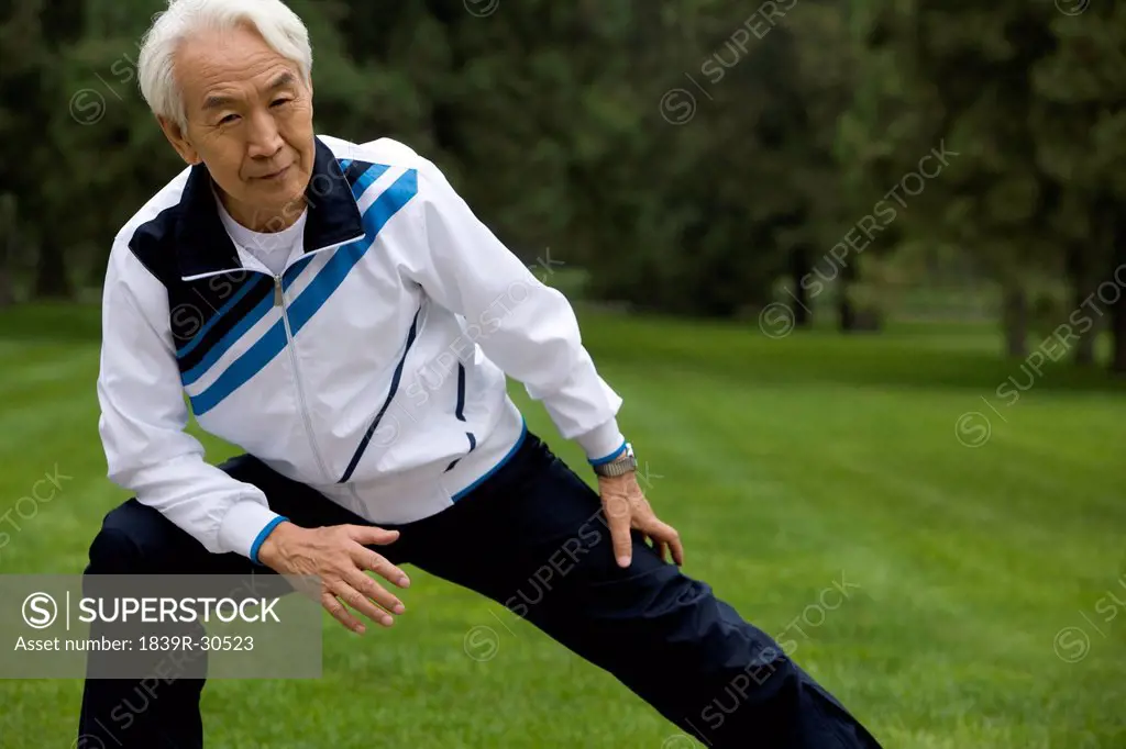 Senior Man Stretching in a Park