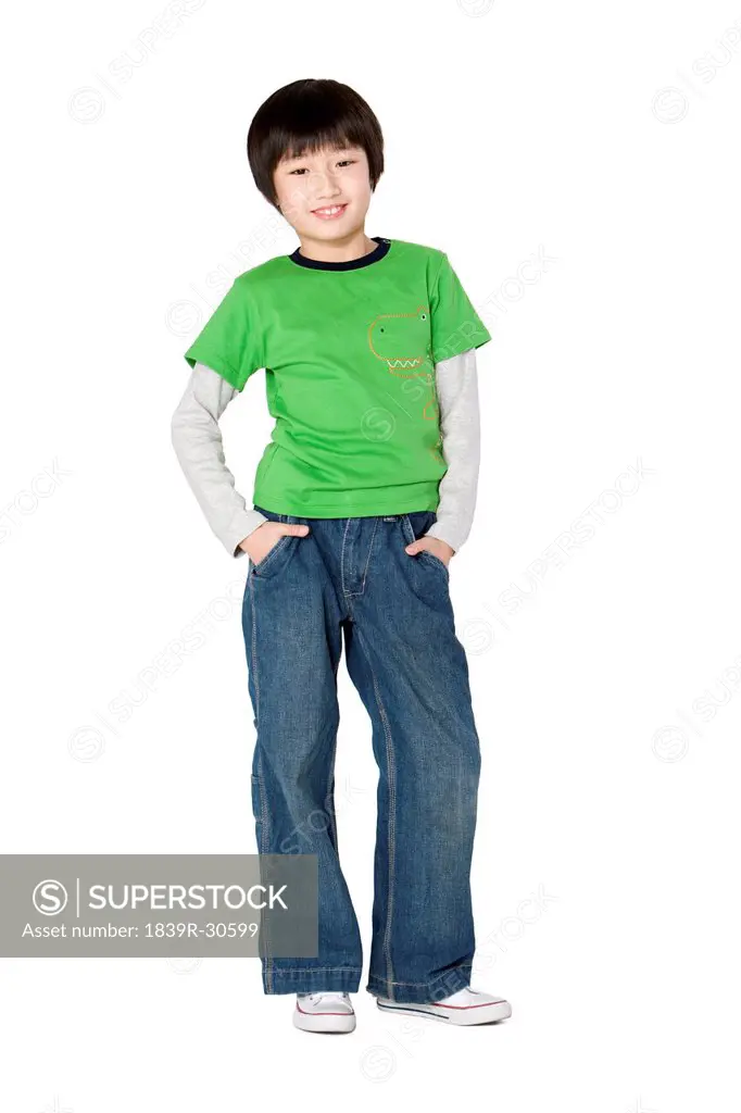 Young boy standing with hands in pockets