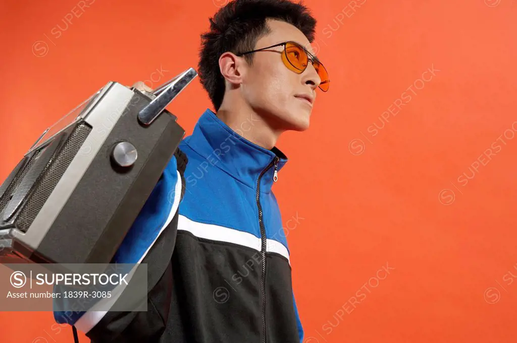 Young Man Holding Stereo
