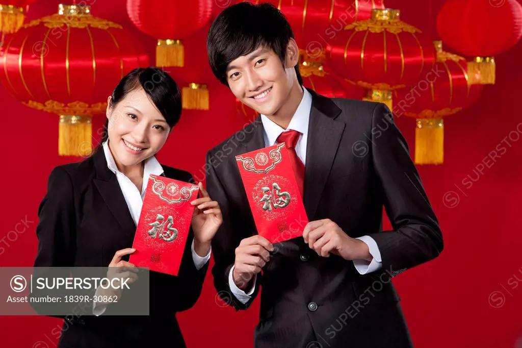 Business Colleagues Holding Red Envelopes